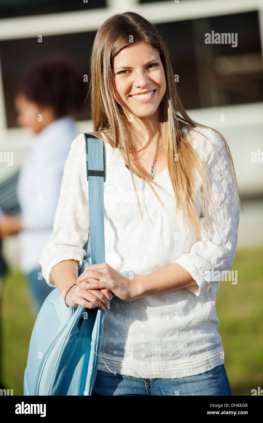 Happy Woman Carrying Shoulder Bag Standing On Campus Stock Photo Alamy