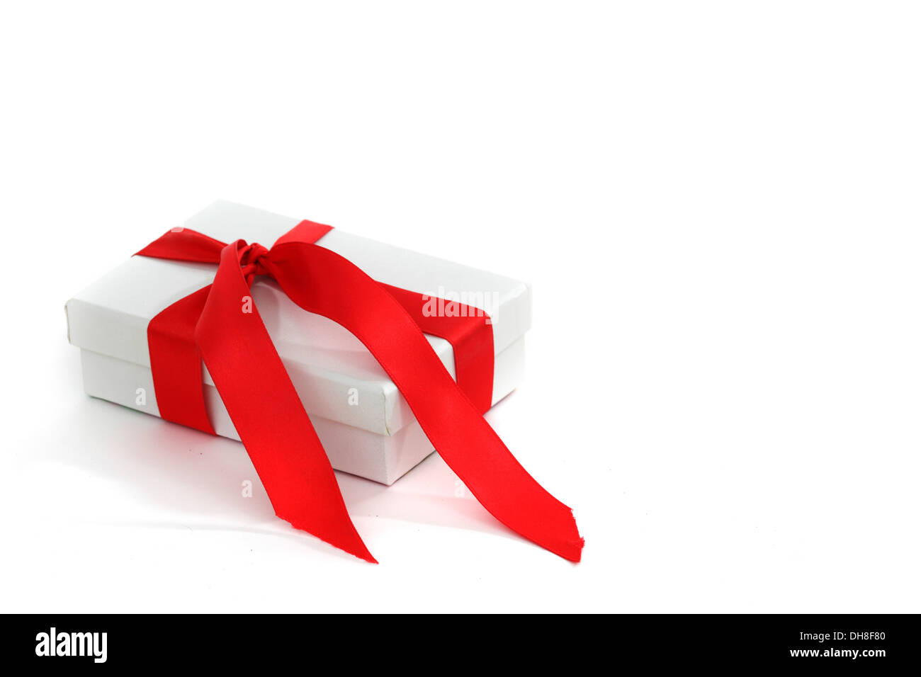 White christmas gift with red ribbon hi-res stock photography and ...