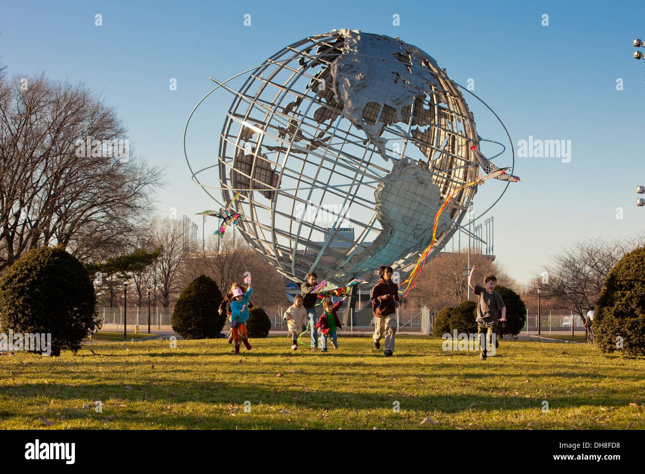 Children flying kites in front of the Unisphere, Flushing Meadow, NYC Stock Photo Alamy