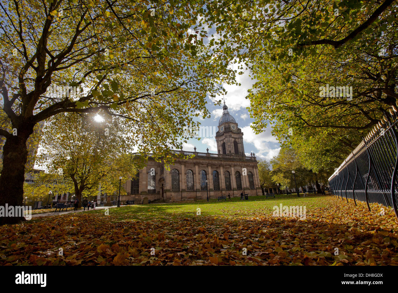 St Philips Cathedral grounds, Birmingham, in autumn with a sunny sky and fallen leaves Stock Photo