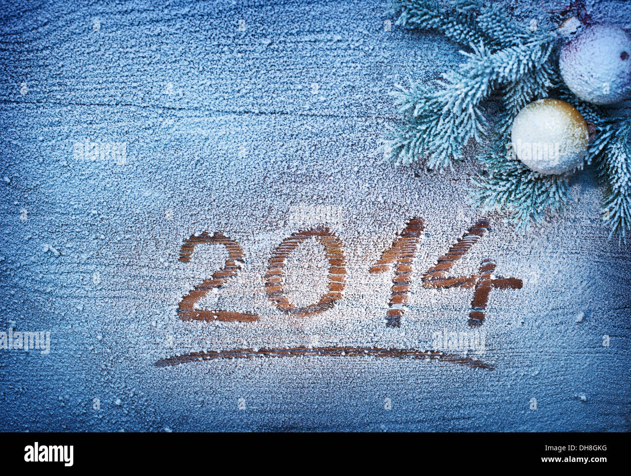 New Year 2014 on snow-covered wooden desk. Stock Photo