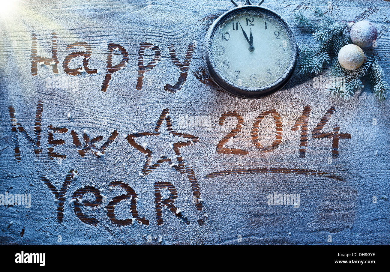 New Year 2014 on snow-covered wooden desk. Stock Photo