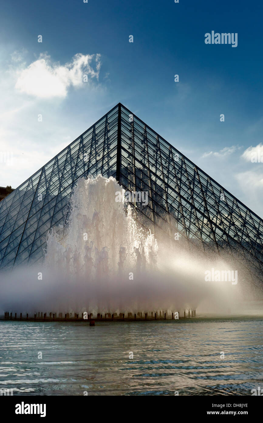 Fountain and glass Pyramid in front of the Louvre Stock Photo