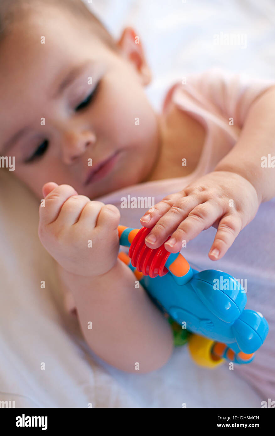 Baby playing with toy Stock Photo