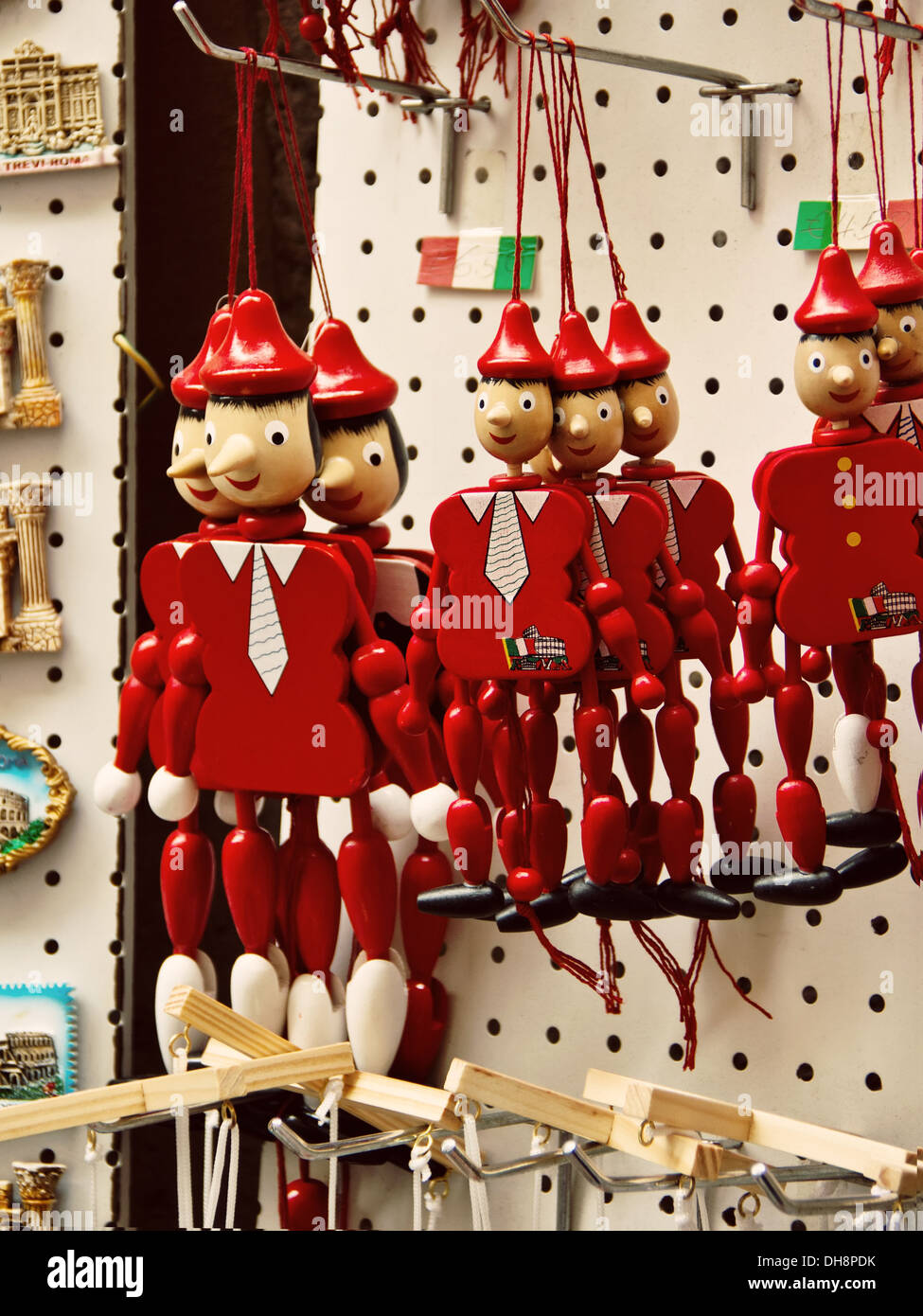 Funny souvenirs wooden Pinocchio marionettes and magnets from Rome, Italy Stock Photo