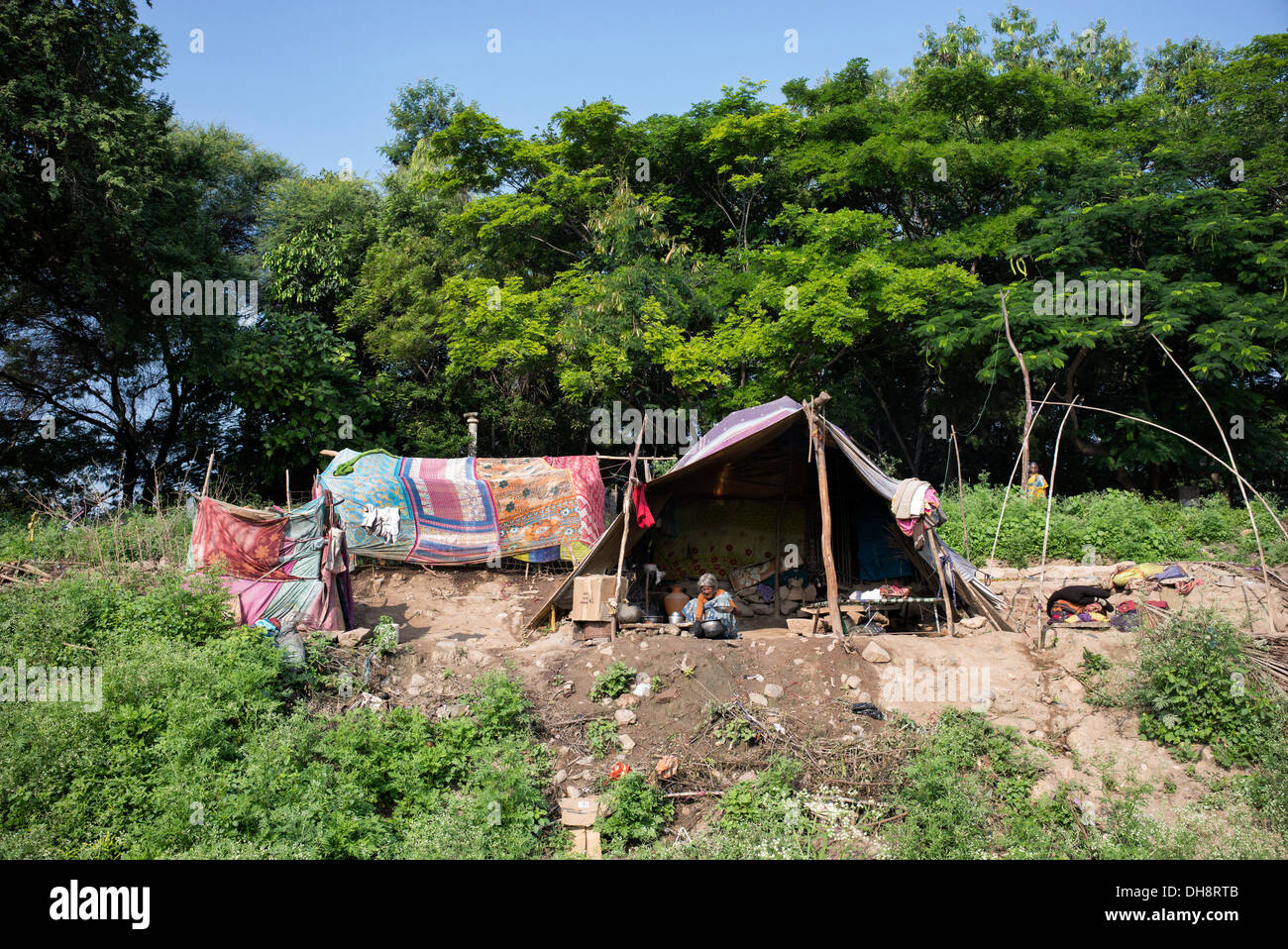 Lower caste Indian woman sitting by her bender / tent / shelter. Andhra Pradesh, India. Stock Photo