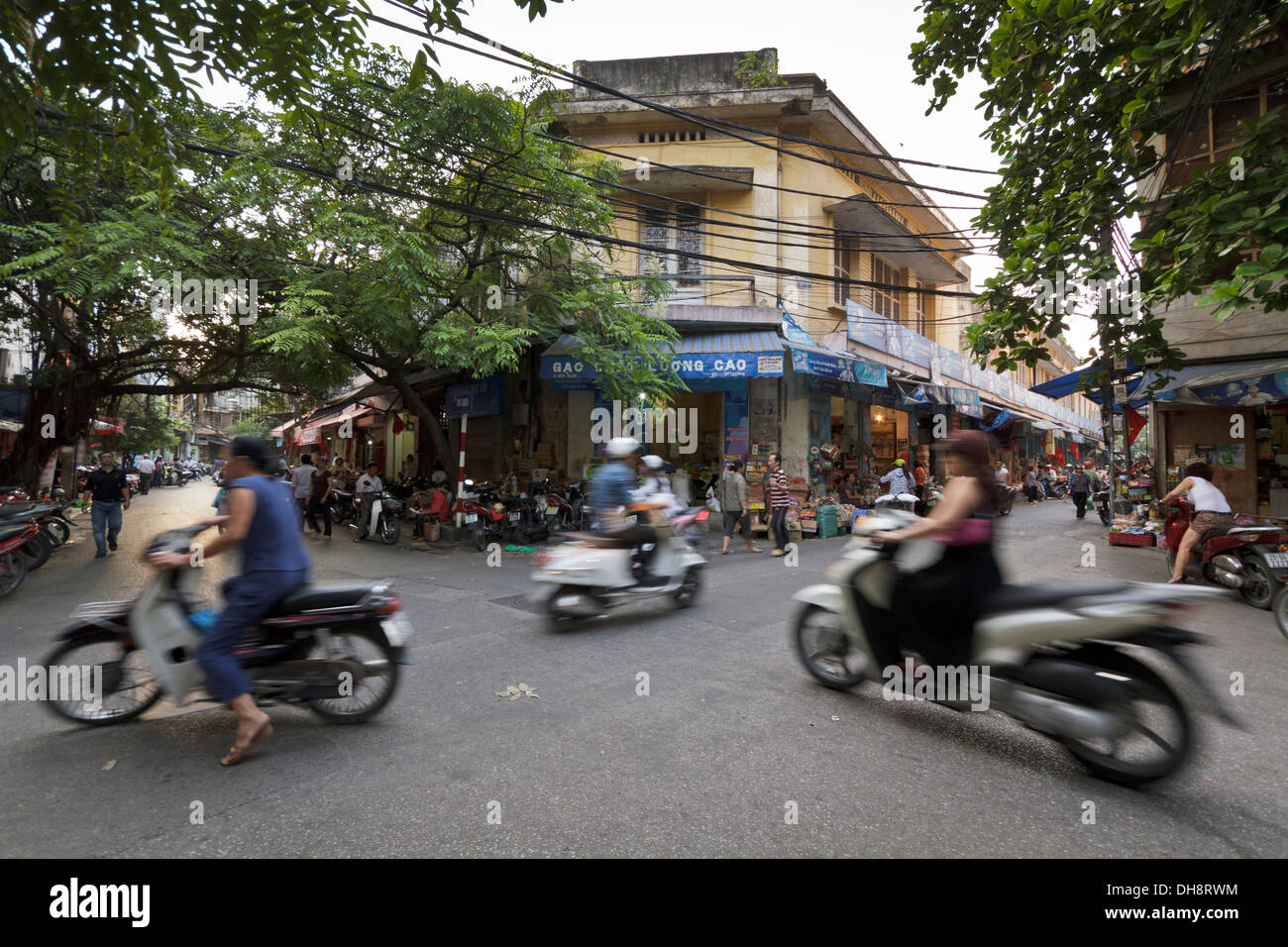 Shot of many scooter and mopeds in the Old Quarter of Hanoi, longer exposure captures motion of scooters. Stock Photo