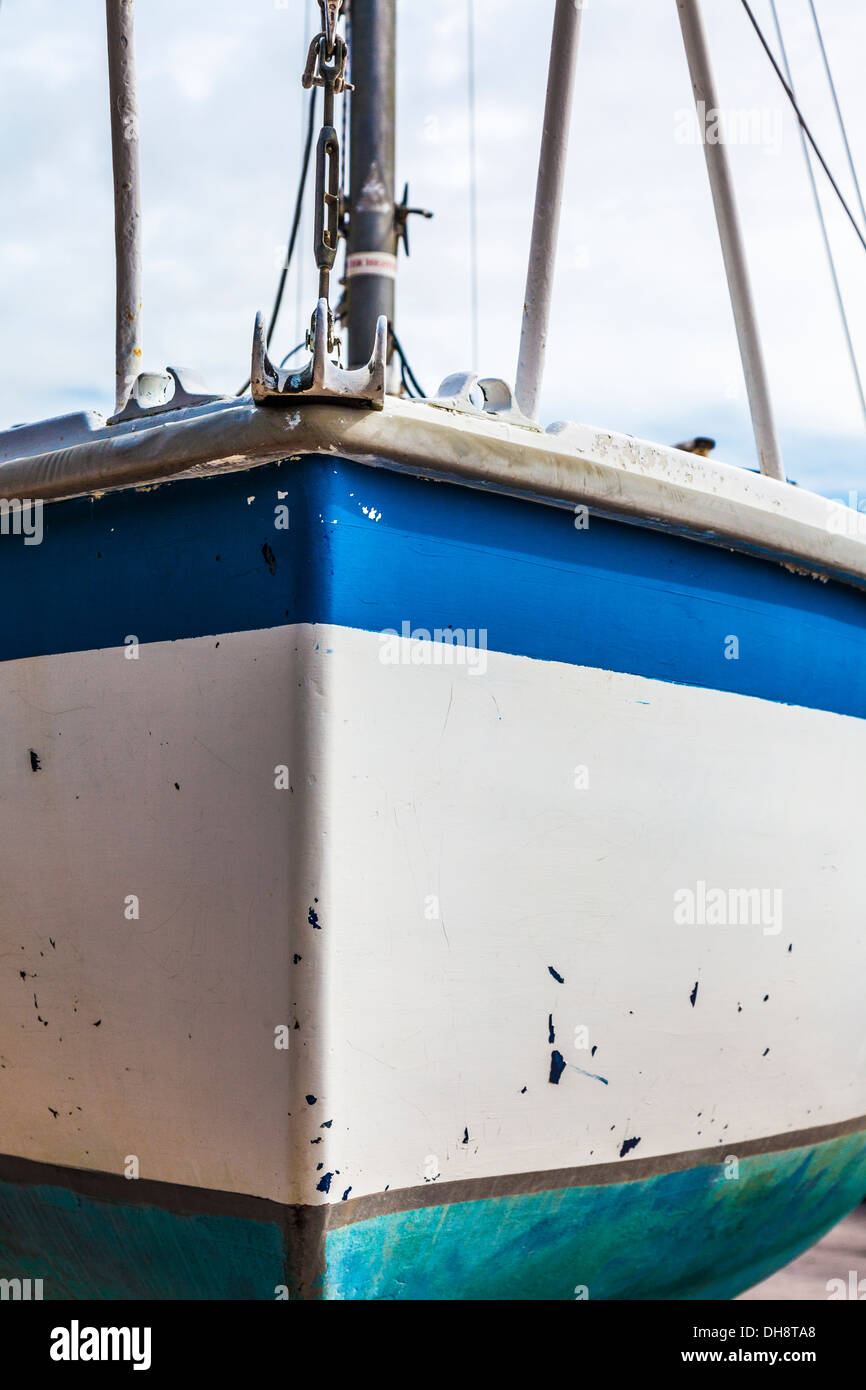 Closeup of the hull of a yacht in dry dock awaiting maintenance and