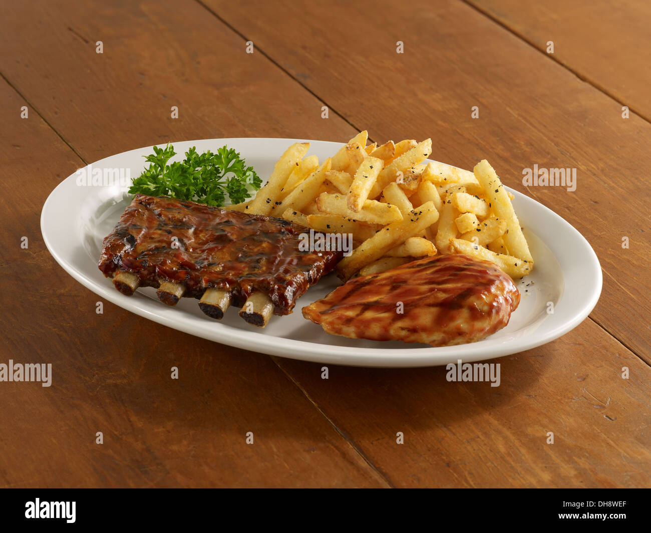 BBQ chicken and ribs with fries Stock Photo