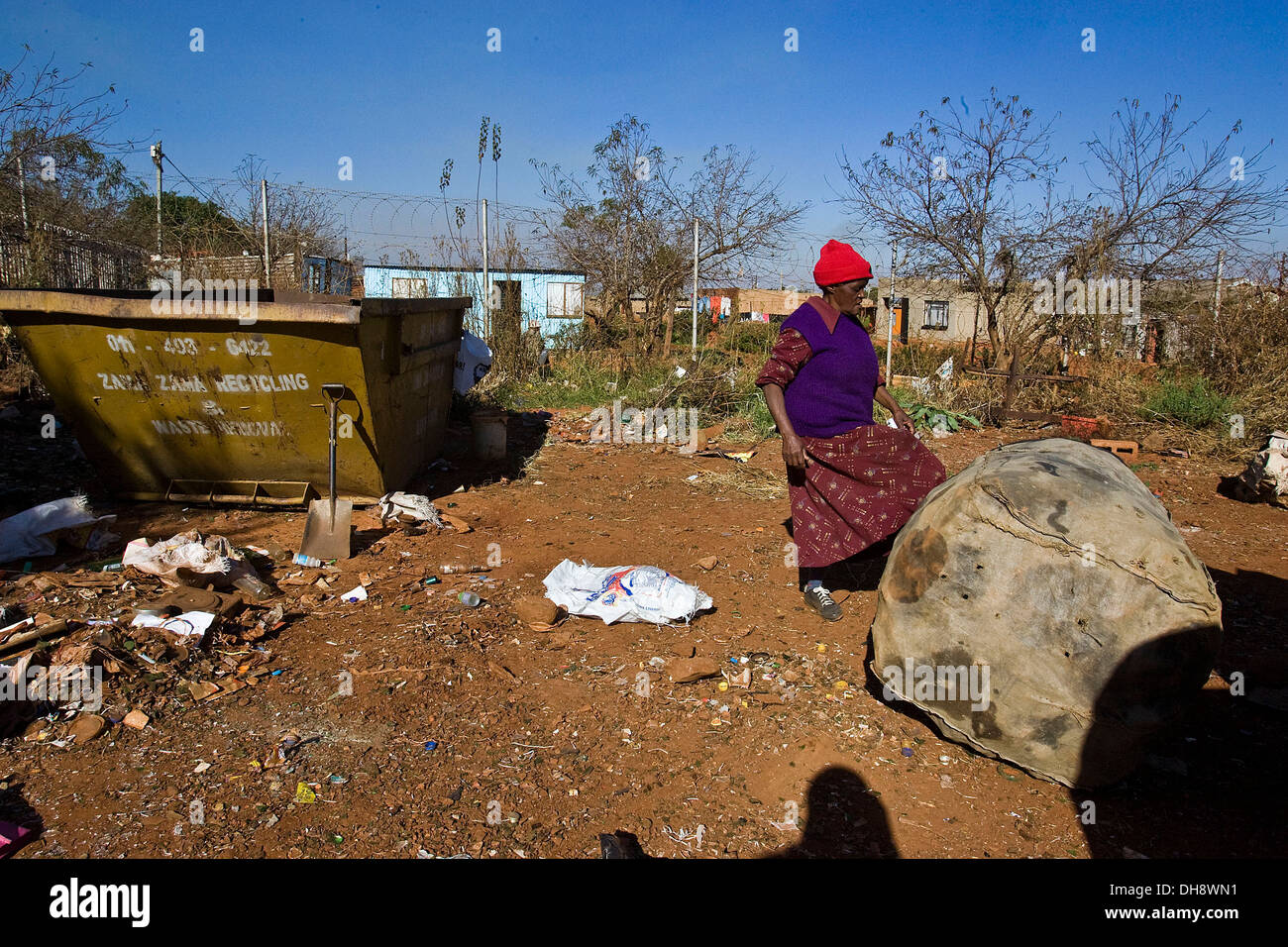 A local woman brings her plastic bottles for recycling in exchange for