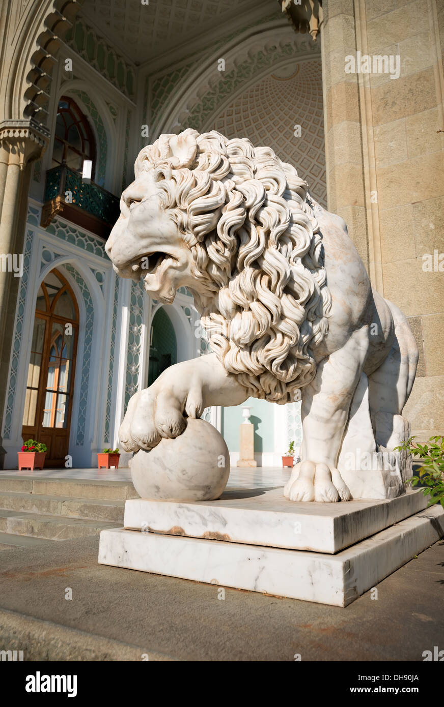 Sculpture of lion with a ball on a background of palace Stock Photo - Alamy