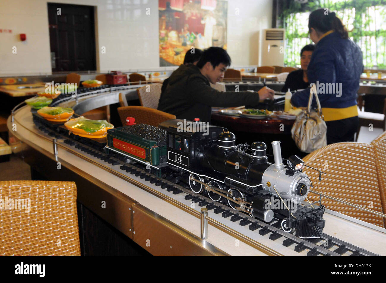 Choo-Choo Your Food! A railway-themed restaurant in Nanjing, China has replaced the standard conveyer belt method of choosing Stock Photo