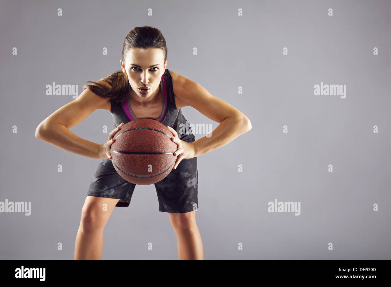 Portrait of young female basketball player passing the ball. Beautiful