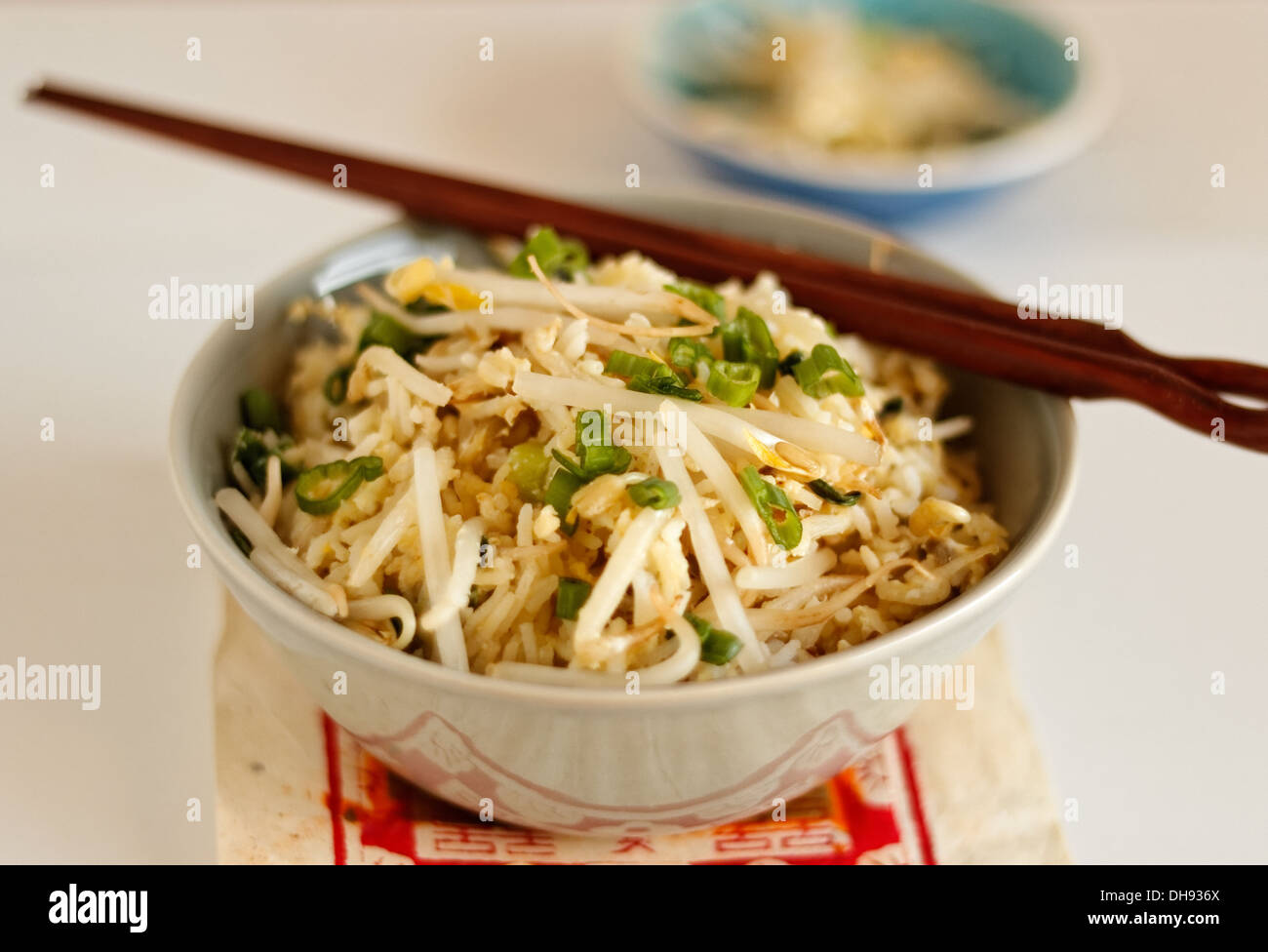 Vegetable stir-fry in a bowl with chopsticks Stock Photo