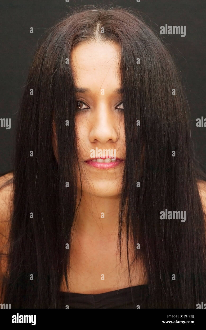Portrait of an attractive woman on black background Stock Photo - Alamy