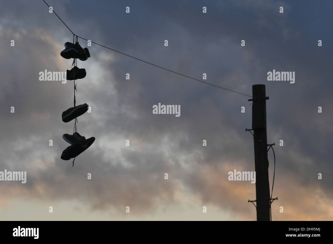 Shoes hanging from a power line shoefiti Stock Photo Alamy
