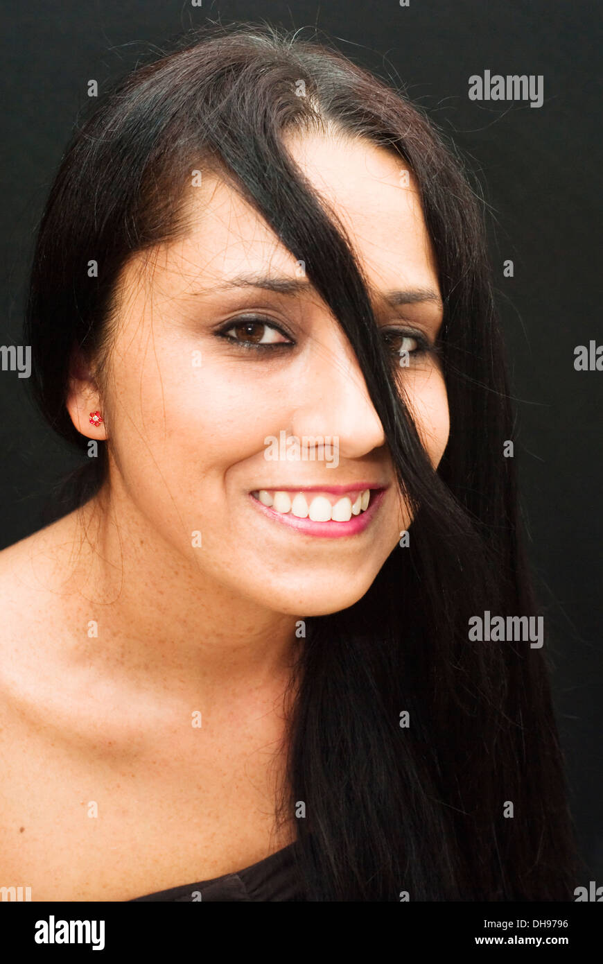 Portrait of an attractive woman on black background Stock Photo - Alamy