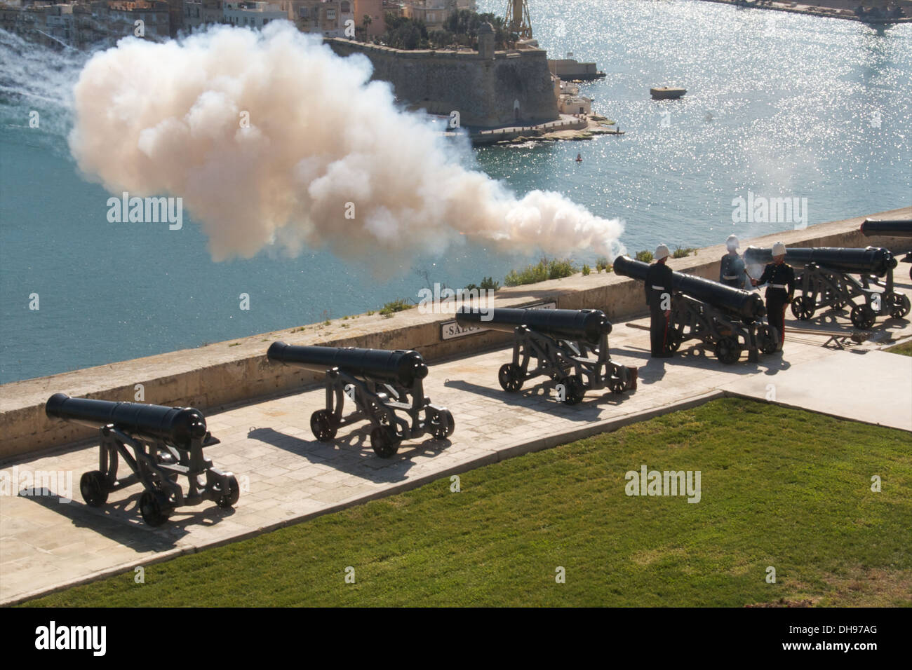 A solider fires a canon for the 12 o' clock gun salute at the Upper Barrakka Gardens, Valetta