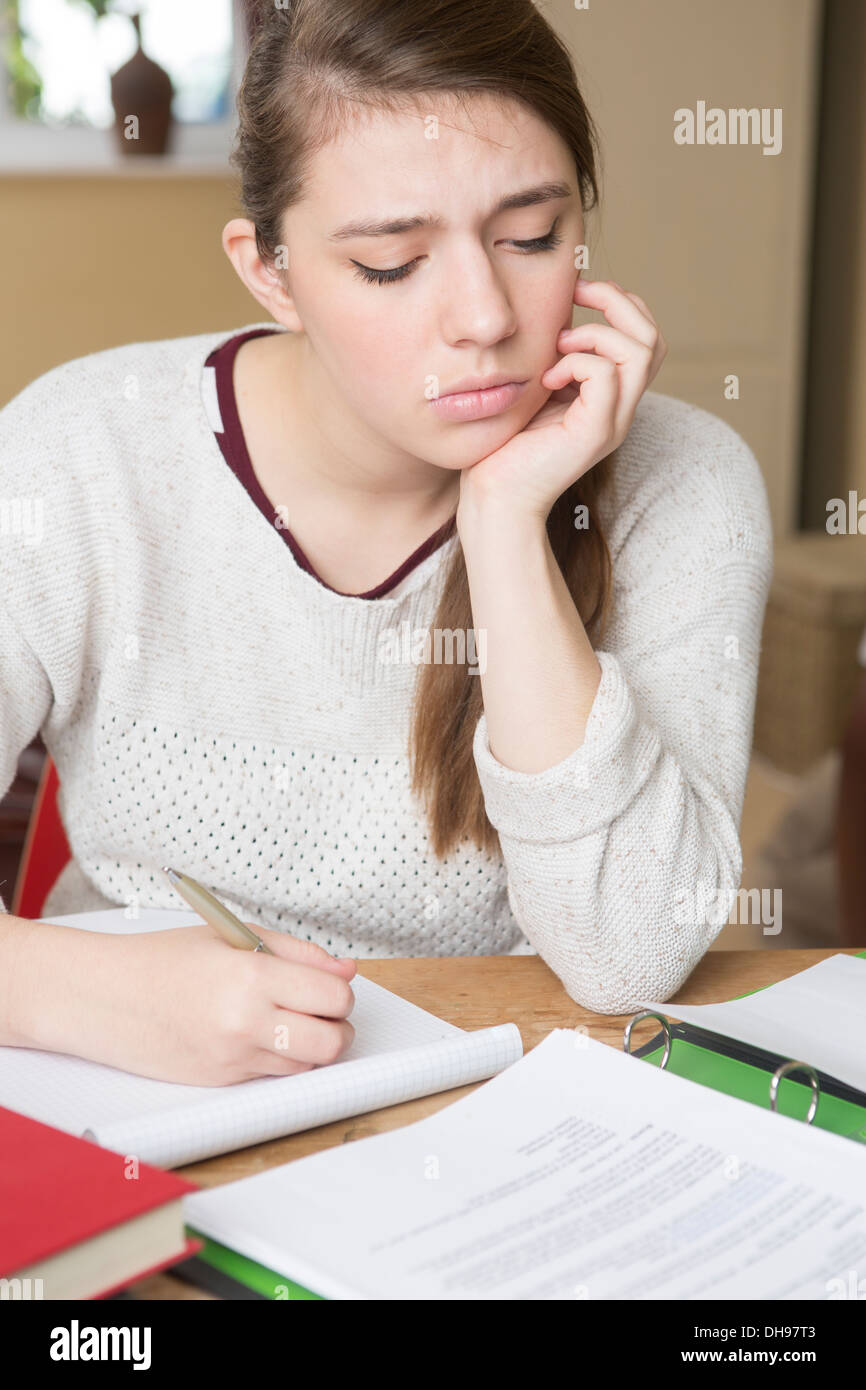 Stressed Teenager Studying At Home Stock Photo