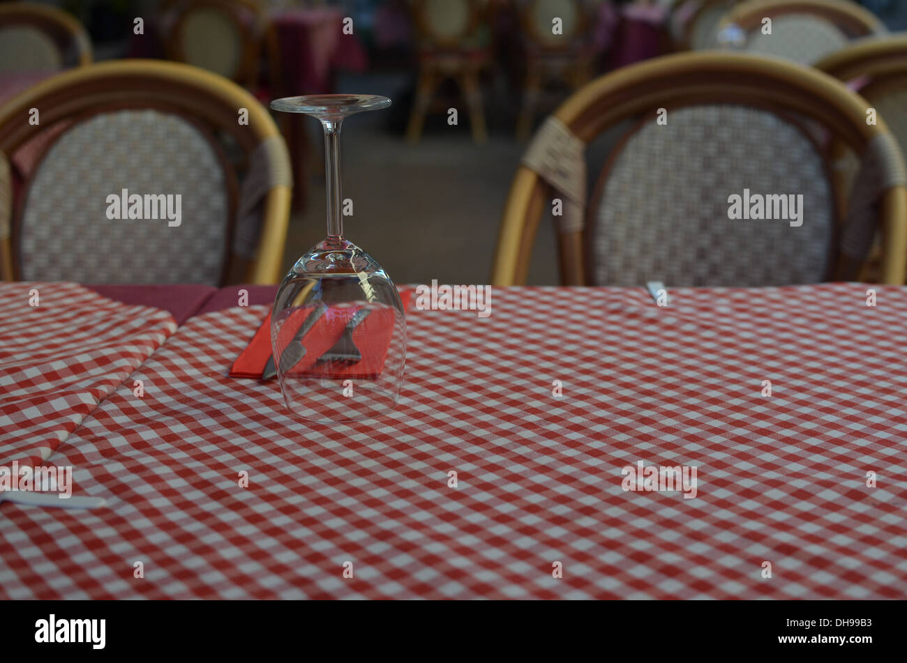 Table at a restaurant with red and white check table cloth Stock Photo