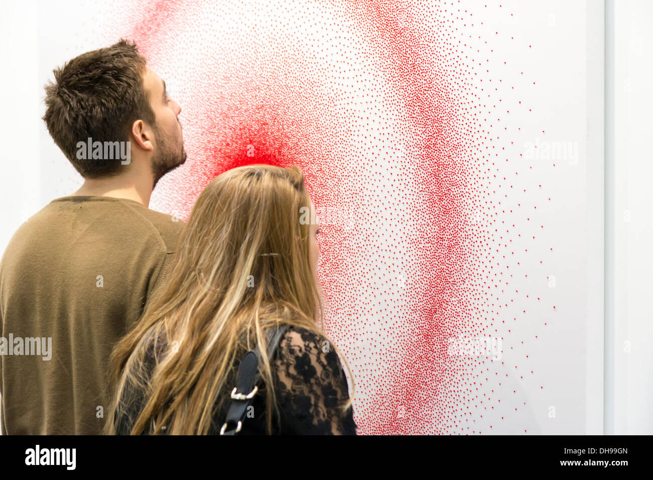 Couple looking very deeply red dots by Piotr Uklanski at the Fiac 2013 ...