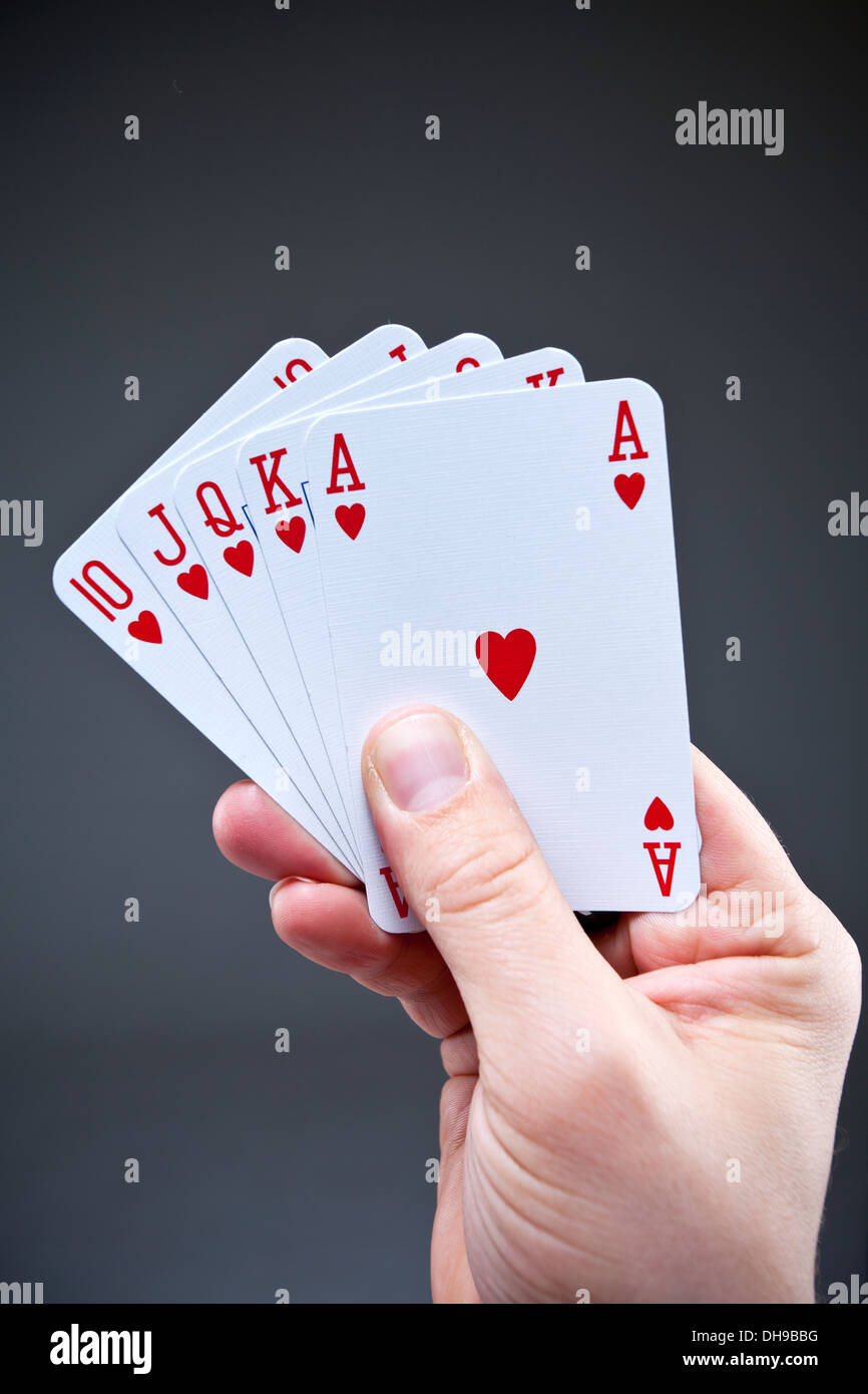 Playing cards being held in mans hand Stock Photo - Alamy