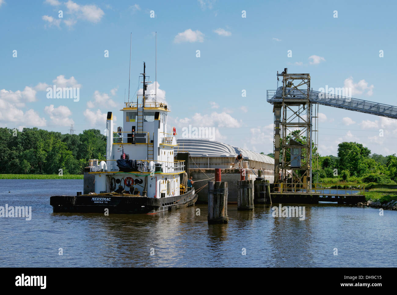 River tugboat pushes a grain barge into a granary pier on the Nanticoke River, in Seaford