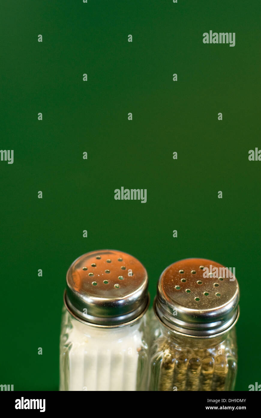 Salt and pepper shakers on a green diner countertop Stock Photo