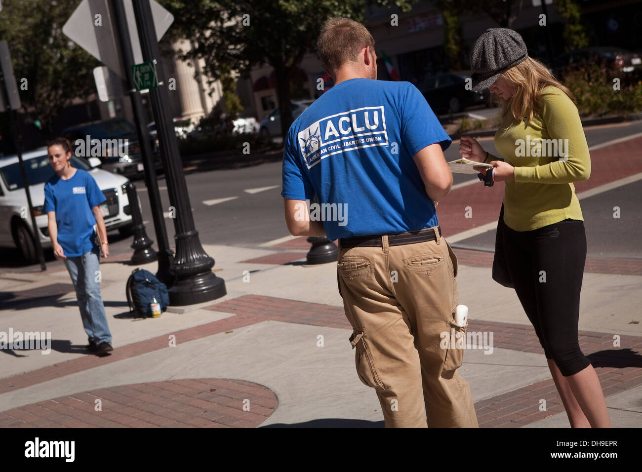 A man wearing an ACLU shirt asks a woman to sign a petition in Pittsfield, Massachusetts Stock Photo