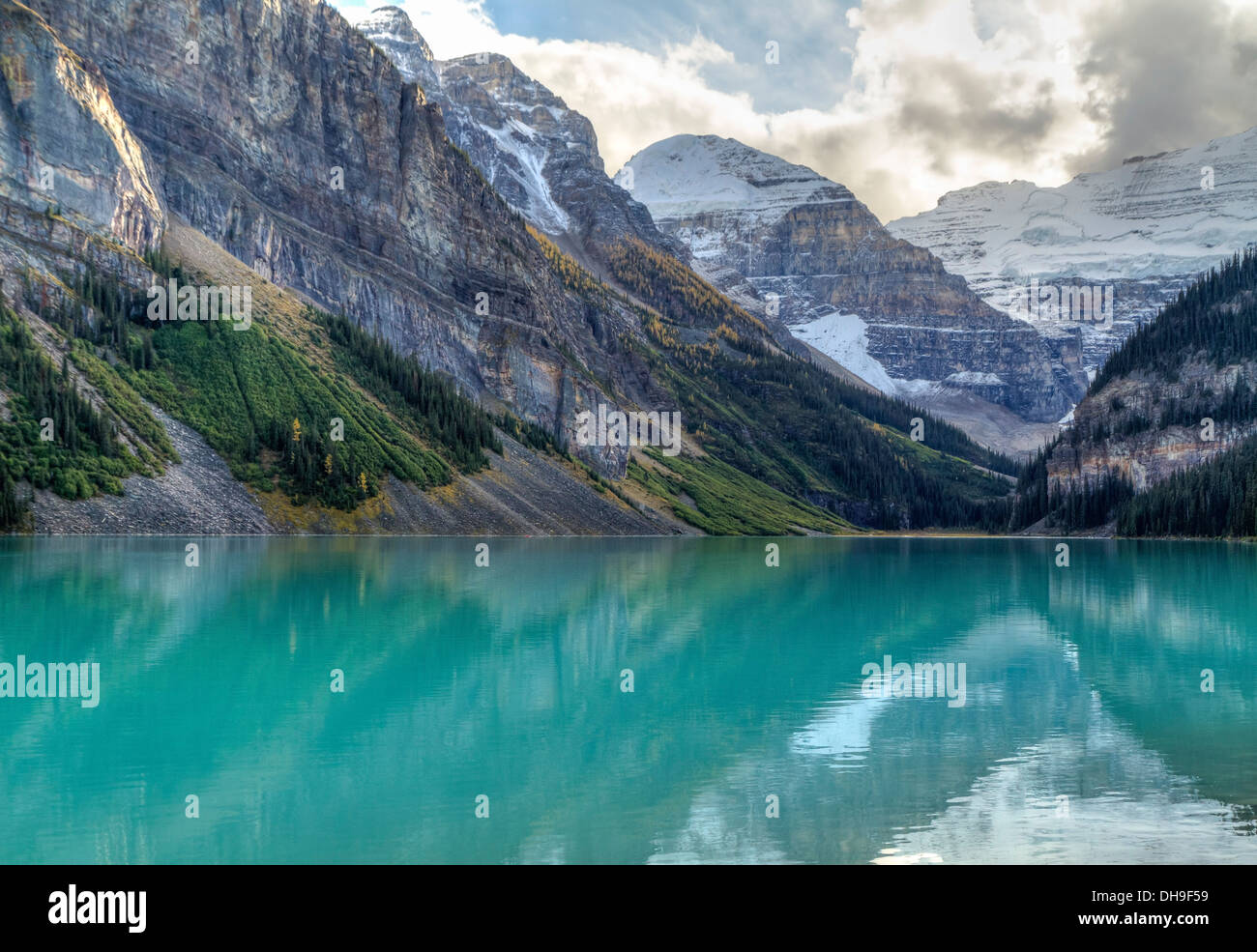 Mountains and glaciers reflected in the idyllic azure glacial waters of Lake Louise, Alberta, Canada Stock Photo