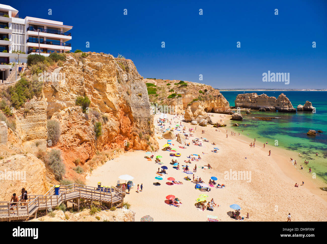 Holidaymakers sunbathing on Praia da Dona Ana Lagos Algarve Portugal EU Europe Stock Photo