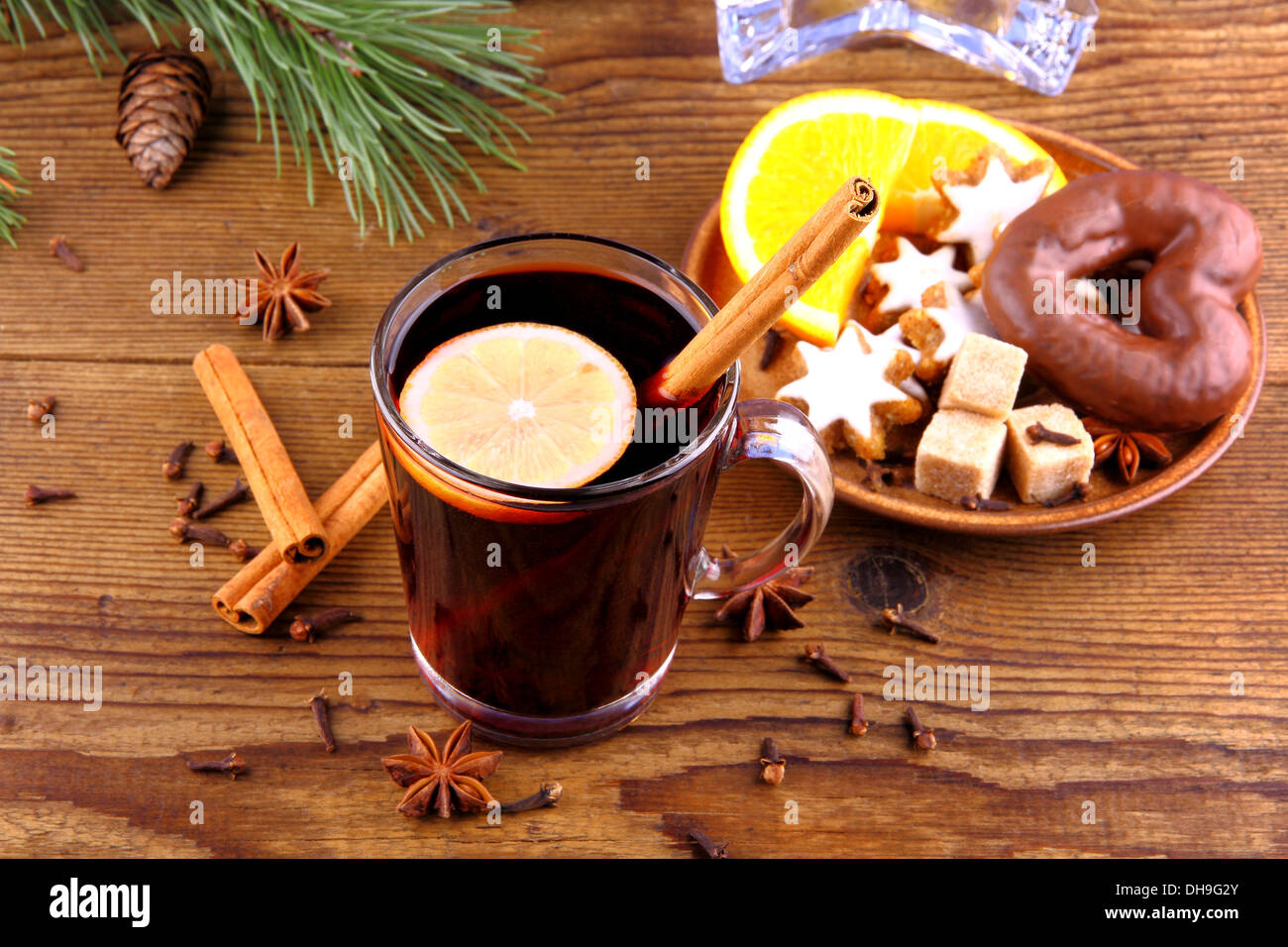 Mulled wine in glass with cinnamon stick and sweets, top view Stock Photo