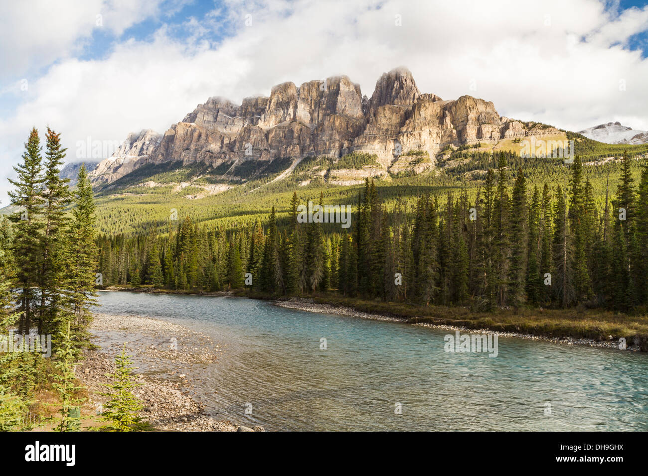 Castle Mountain emerges from the clouds above the Bow River in Banff National Park, Alberta Stock Photo