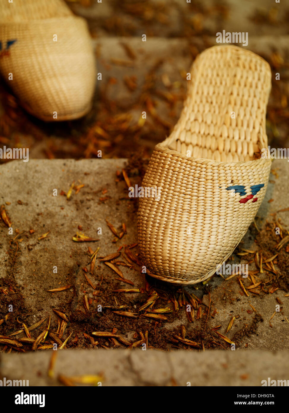 A pair of straw sandals on the stairs Stock Photo