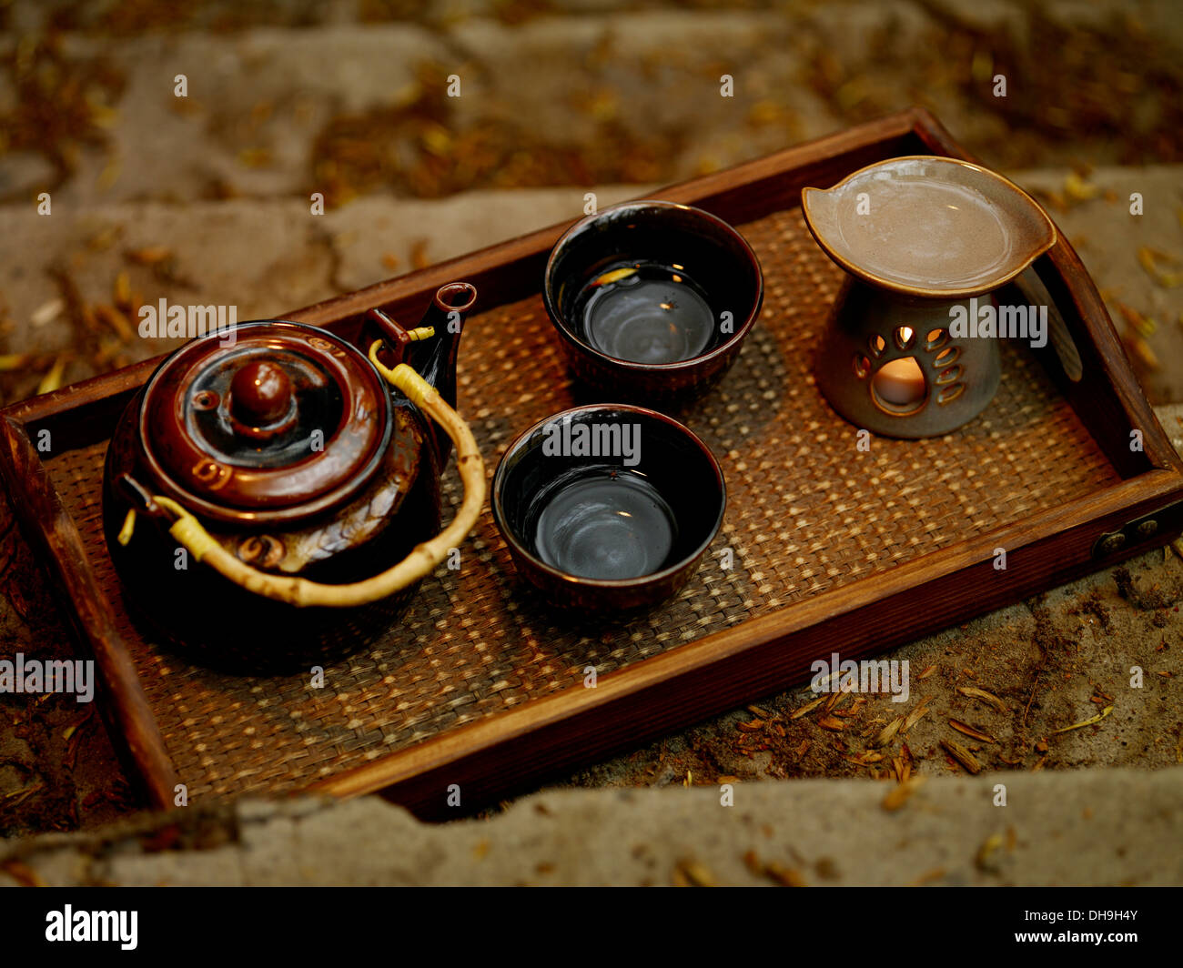 Chinese traditional tea utensil, tea cups, teapot and oil burner on tea board Stock Photo
