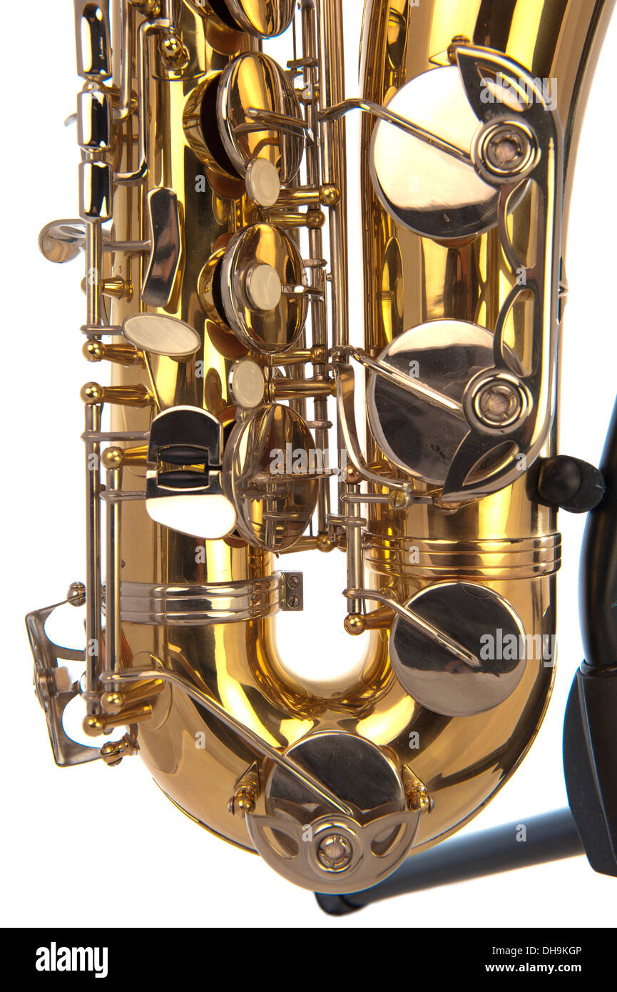 Belly of brass tenor saxophone with silver valves and pearl buttons on a stand in closeup Stock Photo
