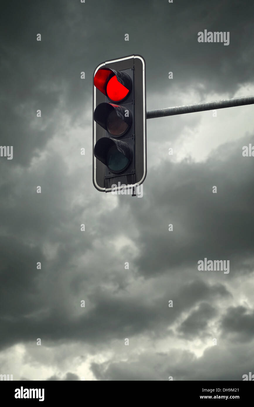Stop light, the red traffic light on a cloudy day Stock Photo