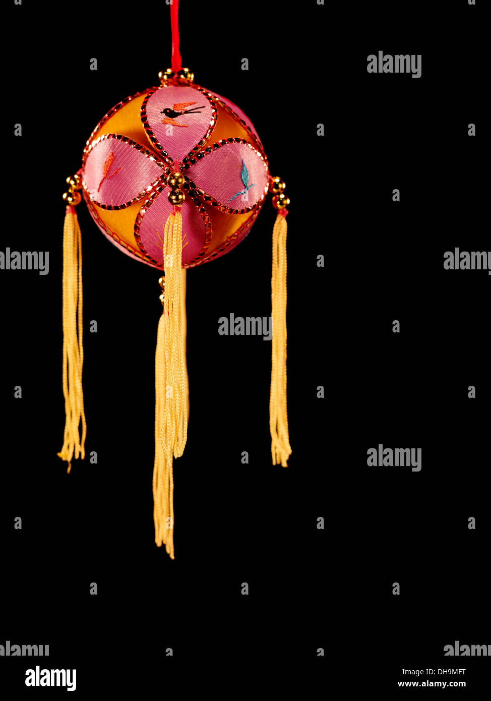 Red silk ball with yellow tassels Stock Photo