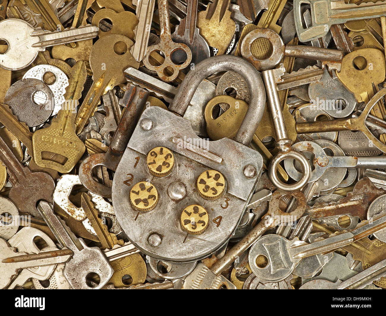 Old lock on a lot metal keys background Stock Photo - Alamy