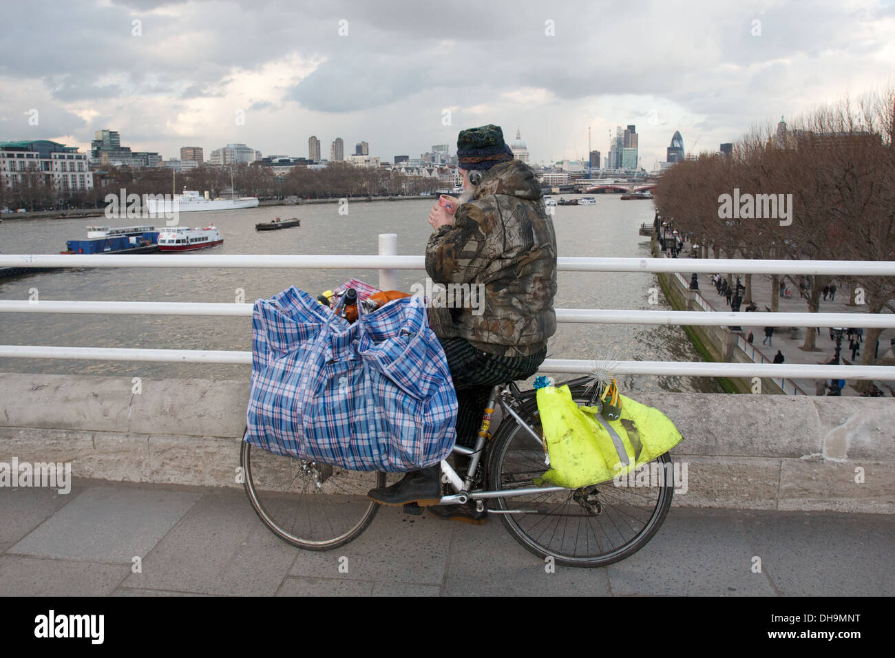 A Homeless Man Sits With His Bike Overlooking The River Thames On Waterloo Bridge With Bags And Possessions Stock Photo Alamy