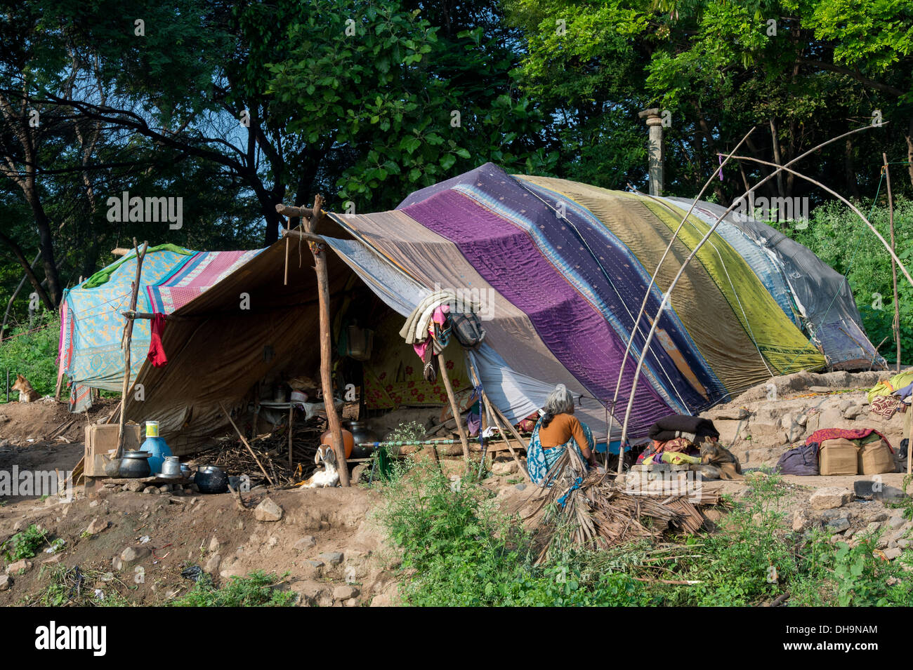 Lower caste Indian woman sitting outside her bender / tent / shelter. Andhra Pradesh, India. Stock Photo