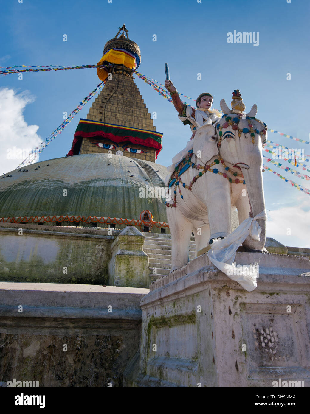 Buddhist Shrine Boudhanath Stupa with pray flags over blue sky. Nepal, Kathmandu Stock Photo