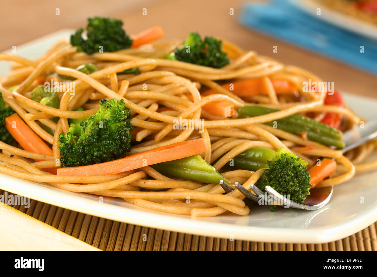 Vegetable and wholewheat spaghetti stir fry with fork (Selective Focus