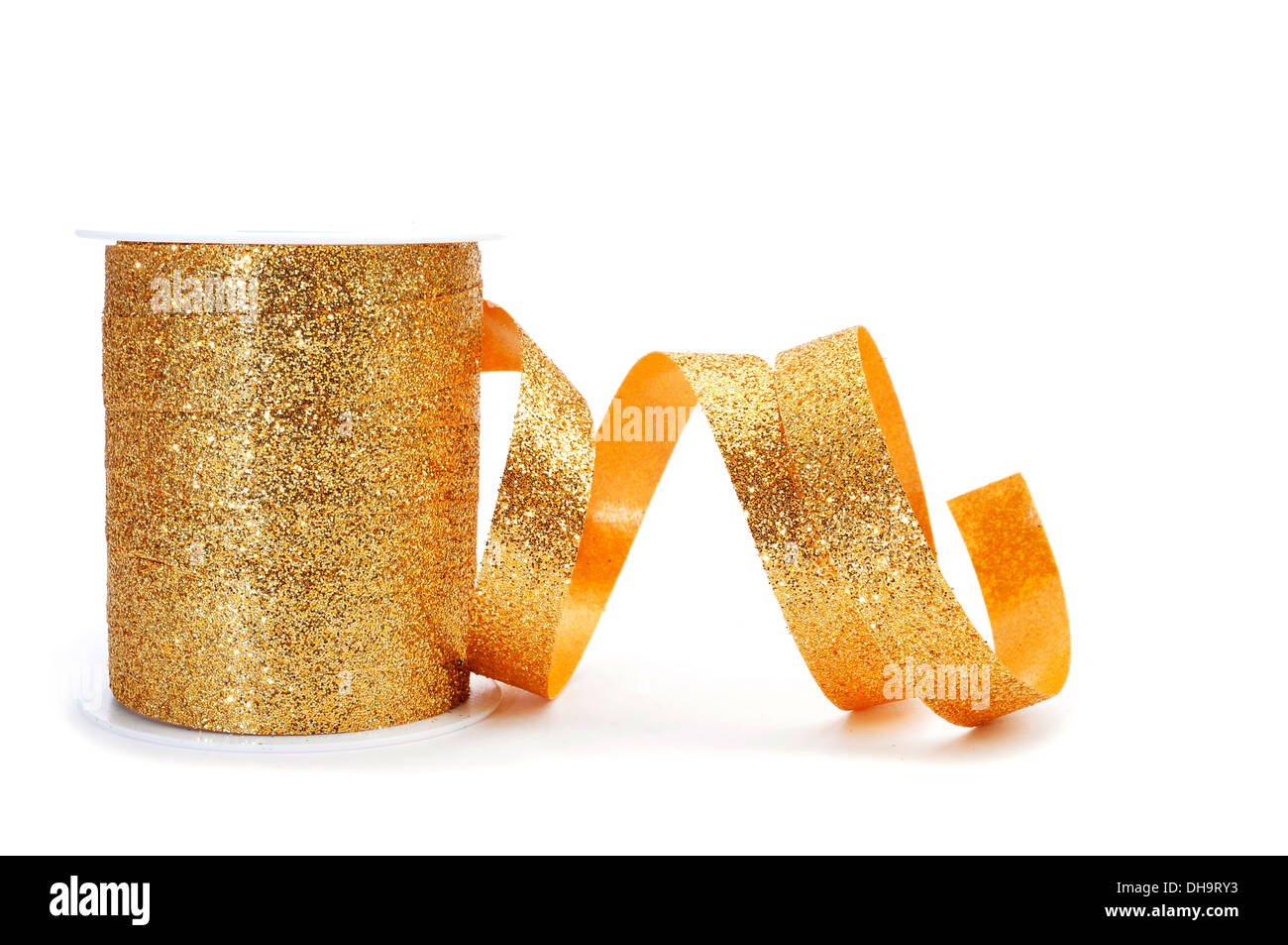 a roll of golden ribbon on a white background Stock Photo - Alamy