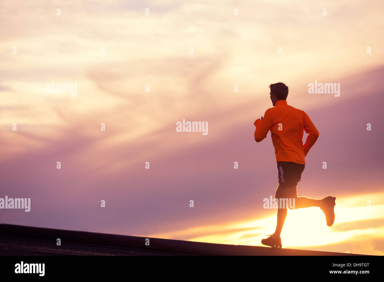 Male runner silhouette, Man running into sunset, colorful sunset sky ...