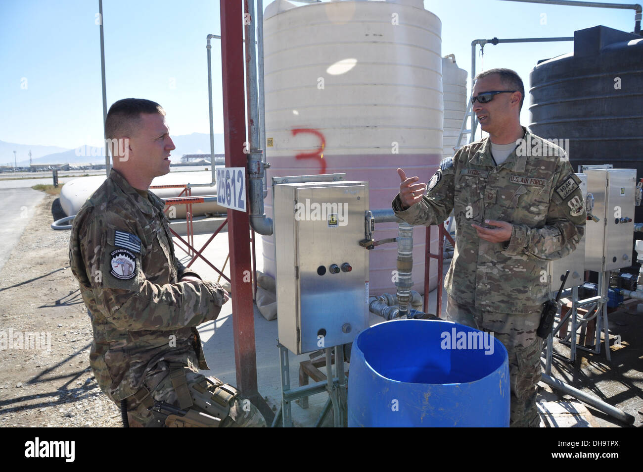 Master Sgt. Paul Titus, a native of Denver, Colo., talks with Master Sgt. Andrew Davis, a resident of Moscow, Tenn., on Bagram Air Field, Afghanistan, Nov. 2, 2013. Both are 455 EAMXS production superintendents who have deployed from Seymour Johnson Air F Stock Photo