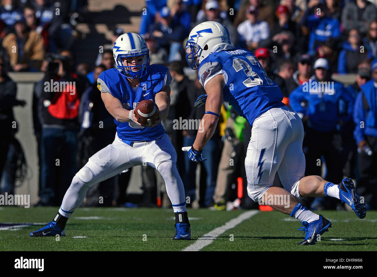 Air Force quarter back Nate Romine, a freshman, hands off the ball to running back Anthony LaCoste, a senior, to rush the ball 73 yards in a run that lead to a Falcon touchdown during the first quarter of the game versus Army at Falcon Stadium in Colorado Stock Photo