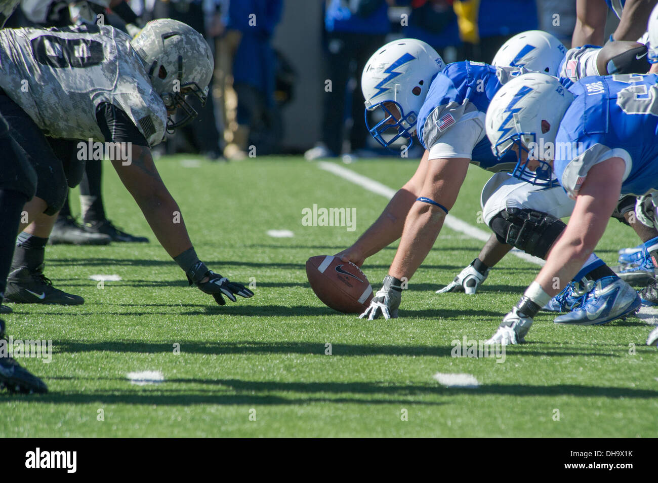 Army and Air Force football players face off at the line of scrimmage at Falcon Stadium during an Air Force verses Army football game in Colorado Springs, Colorado, Nov. 02, 2013. Stock Photo