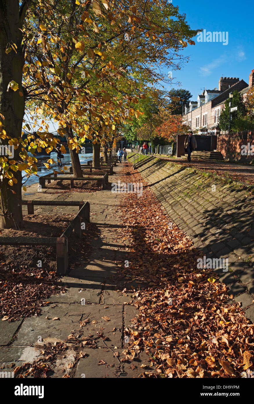 People walking on path footpath beside the River Ouse in autumn York North Yorkshire England UK United Kingdom GB Great Britain Stock Photo