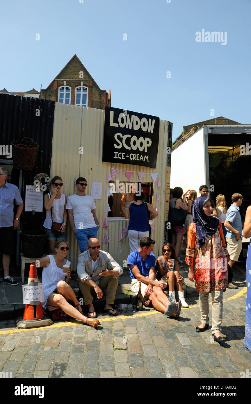London Scoop Ice Cream with people sitting around eating ice cream and chilling out Columbia Road Market Tower Hamlet London UK Stock Photo